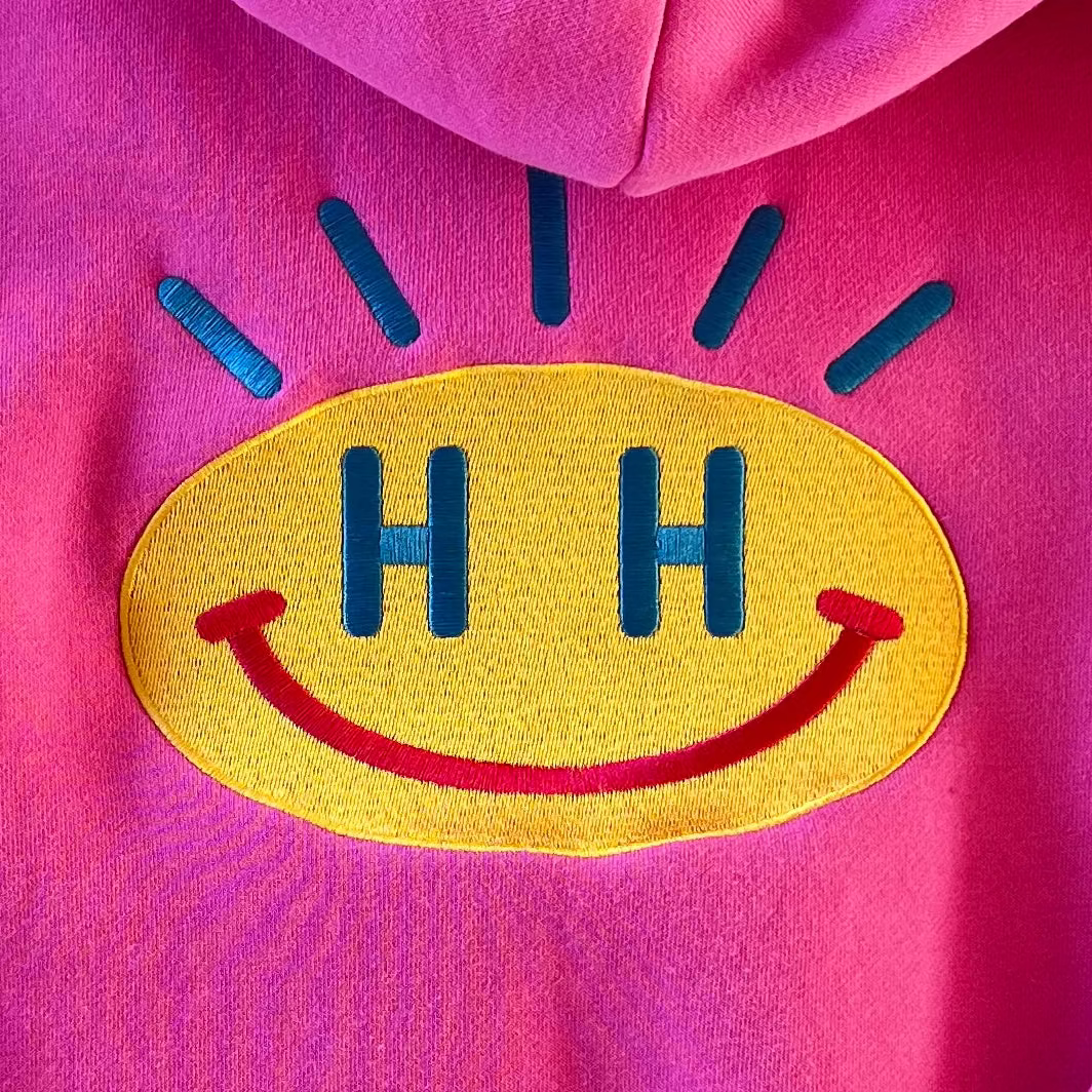 Bubblegum hot pink teen hoodie with Tatami embroidery smiley face detail in the back. 