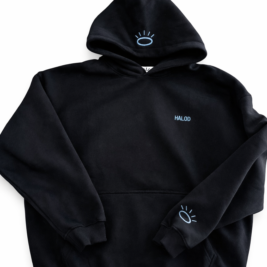 Front view of jet black sweatshirt featuring flat woven Tatami embroidery in vibrant Tahoe Blue.
