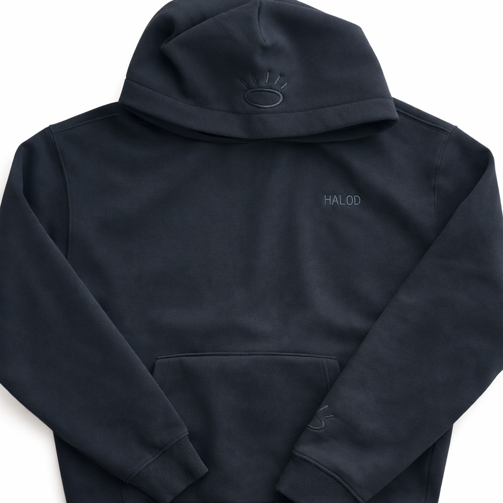 Front view of jet black sweatshirt featuring flat woven black Tatami embroidery on chest and hood. 
