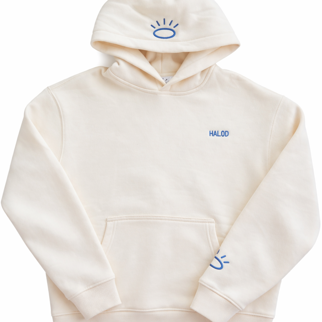 Front view of cream sweatshirt featuring flat woven Tatami embroidery in Tahoe Blue. Halo embroidery on hood and on sleeve. 
